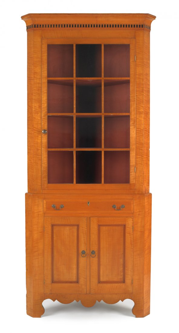Pennsylvania Federal tiger maple corner cupboard: Pennsylvania Federal tiger maple corner cupboard, 20th c., in two parts, the upper section with inlaid and dentil cornice, over a single twelve-lite door, all over a boldly scalloped apron, resting on