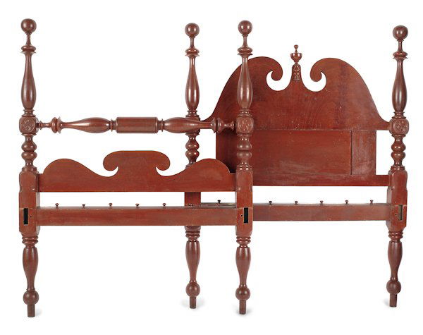Pennsylvania painted tall post bed, ca. 1830, w: Pennsylvania painted tall post bed, ca. 1830, with carved boldly turned posts with philphlots and a broken arched paneled headboard, retaining its original bright salmon surface, 63 3/4'' h., 49 1/2''