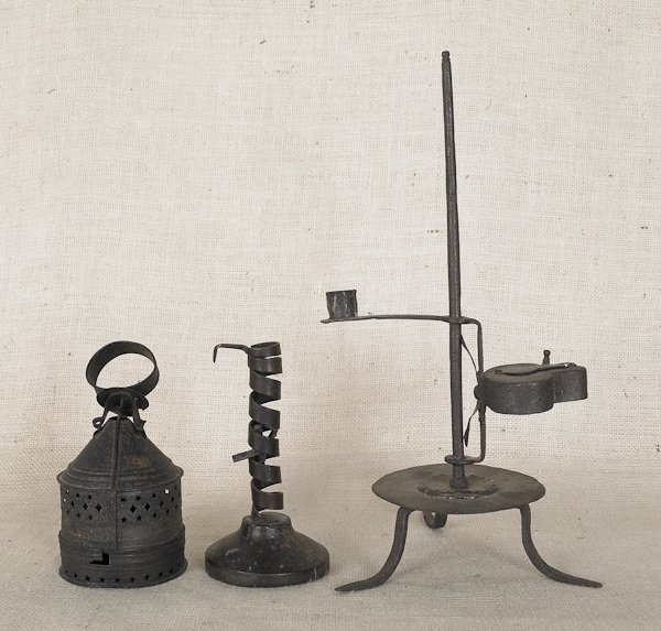 Collection of lighting, early 19th c., to inclu: Collection of lighting, early 19th c., to include an iron table top fat lamp, a tin lantern, and a twist ejector candlestick, tallest - 16''.