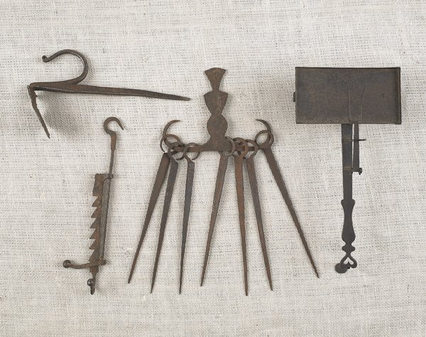 Collection of wrought iron, to include a jamb s: Collection of wrought iron, to include a jamb spike, a miniature saw tooth trammel, a skewer set, and a roaster.