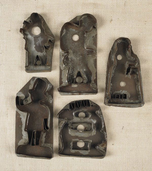 Five tin sheet iron cookie cutters, 19th c., to: Five tin sheet iron cookie cutters, 19th c., to include a gentleman in a top hat, a chimney sweep, etc., tallest - 8 3/4'' h.