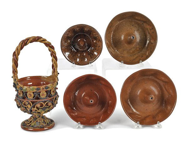 Four Pennsylvania redware molds, 19th c., togethe: Four Pennsylvania redware molds, 19th c., together with a French redware basket, 10'' h.