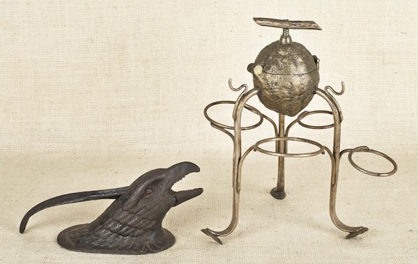 Silver plated lemon squeezer on stand, ca. 1900,: Silver plated lemon squeezer on stand, ca. 1900, 12'' h., together with a cast iron eagle head nut cracker, 4 1/2'' h.