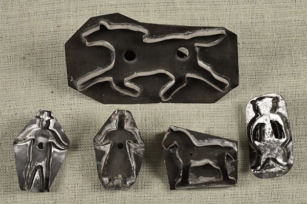 Five tin cookie cutters, 19th c., to include a fi: Five tin cookie cutters, 19th c., to include a figural man and woman, stamped H. Oppelt, a running horse, etc., horse - 6 1/4'' x 11''.