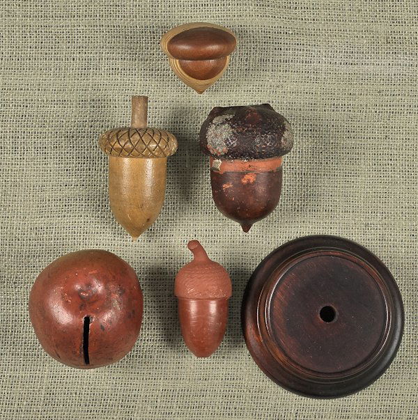 Redware orange bank, 19th c., together with two r: Redware orange bank, 19th c., together with two redware acorns and two wooden acorns, tallest - 4''.