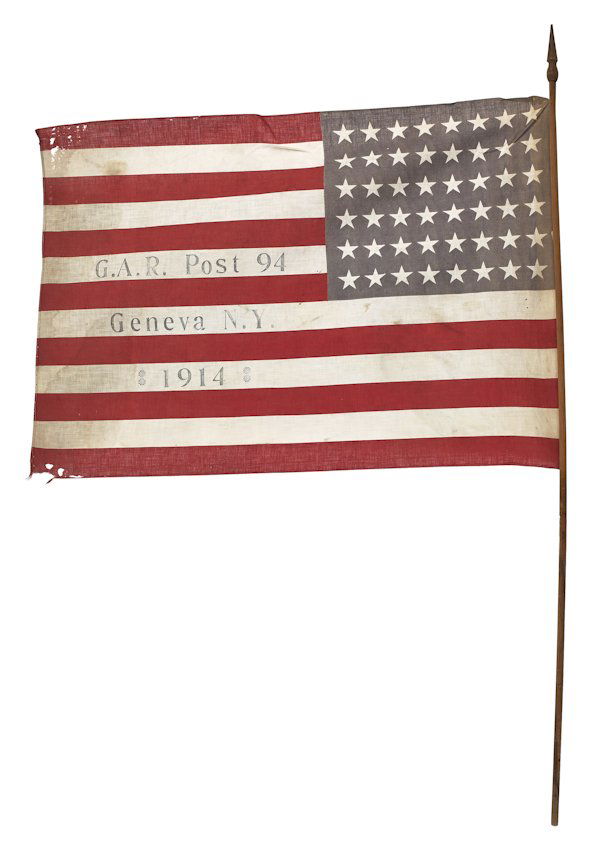 G.A.R. flag, dated 1914, together with a G.A.R.: G.A.R. flag, dated 1914, together with a G.A.R. belt buckle, a cast iron souvenir hat, a leather carry case, a brass powder flask, a carved powder horn with a Native American motif, and a leather shin