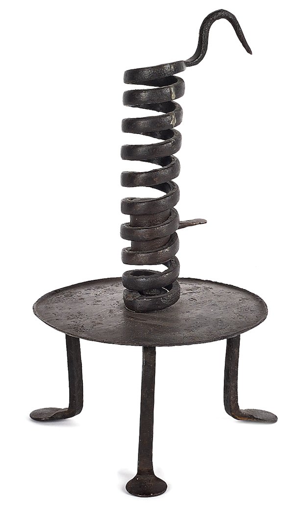 Continental wrought iron spiral candlestick, ca.: Continental wrought iron spiral candlestick, ca. 1800, with a drip pan and penny feet, 11'' h.