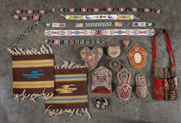 Collection of beaded Native American souvenir ite: Collection of beaded Native American souvenir items, to include pincushions, a bark frame, a woven rug, a pouch, a beadwork frame with a print of Minnehaha, etc.