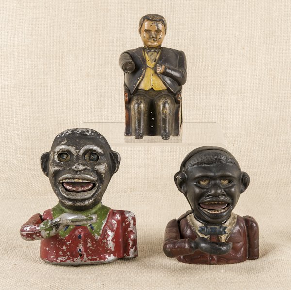 Cast iron Little Joe mechanical bank, 5 1/4'' h.: Cast iron Little Joe mechanical bank, 5 1/4'' h., together with an aluminum black Americana bank, 6'' h., and a Tammany bank.