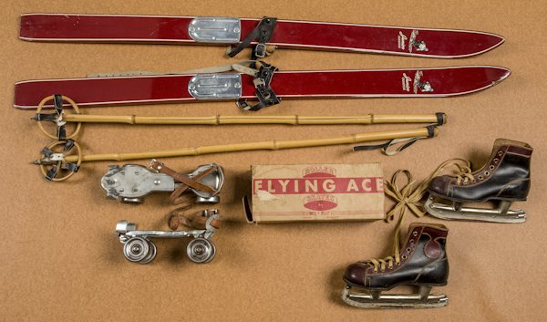 Pair of child's Junior Champion skis, 41'' l., t: Pair of child's Junior Champion skis, 41'' l., together with another set of skis, several pairs of ice skates, and a pair of roller skates with their original box.