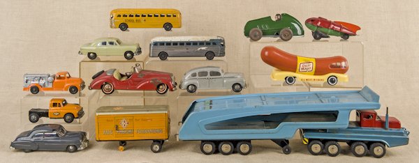 Thirteen miscellaneous vintage vehicles, to inclu: Thirteen miscellaneous vintage vehicles, to include a Weinermobile bank, a pressed steel rocket car, an open wheel racer, etc., longest - 23 1/2''.