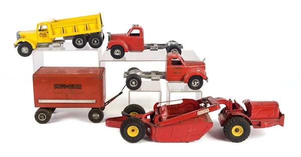 Group of pressed steel toys, to include a Smith M: Group of pressed steel toys, to include a Smith Miller pressed steel S.M.F.D. Tractor, a Smith Miller trailer, a Smith Miller Mack Tractor, a Smith Miller MIC dump truck, and a Doepke Heliner.