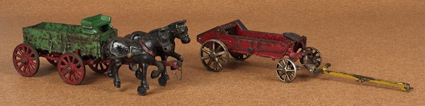 Arcade cast iron McCormick Deering spreader, 14: Arcade cast iron McCormick Deering spreader, 14 1/2'' l., together with a cast iron McCormick Deering buckboard wagon, 12'' l.