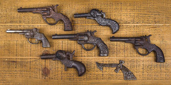 Two cast iron Sambo figural cap guns, 4 1/4'' l.: Two cast iron Sambo figural cap guns, 4 1/4'' l., together with four other cast iron cap guns and a cast iron gun form patented Oct. 1877, 3 3/4'' l.