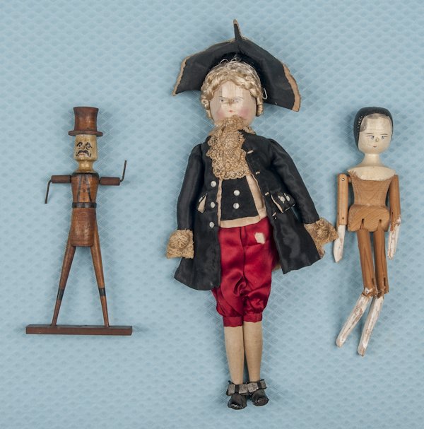 Two peg wooden dolls, tallest - 16'', together wit: Two peg wooden dolls, tallest - 16'', together with a wooden figure of a gentleman in a top hat.