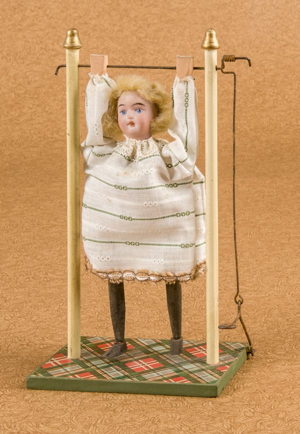 Walther and Sohn bisque head acrobat doll on a wo: Walther and Sohn bisque head acrobat doll on a wood platform, 8 3/4'' h.