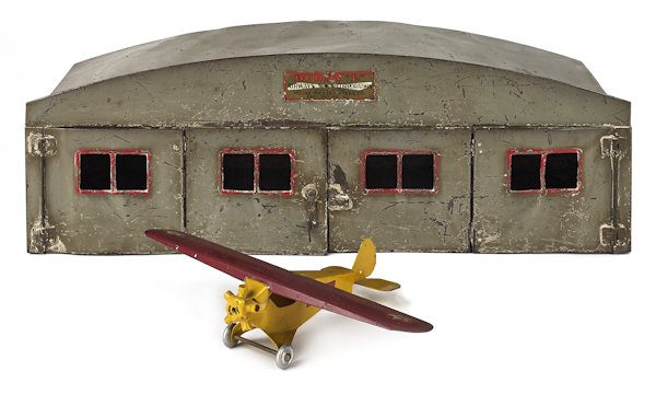 Buddy L pressed steel Monoplane and hanger, 7'': Buddy L pressed steel Monoplane and hanger, 7'' h., 20'' w.