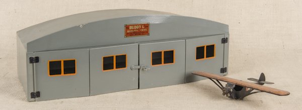 Buddy L pressed steel airplane and hanger, 7 1/4'': Buddy L pressed steel airplane and hanger, 7 1/4'' h., 20'' w.