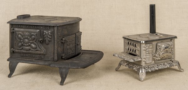 Two cast iron miniature stoves, one Orr Painter: Two cast iron miniature stoves, one Orr Painter & Co., 7'' h., the other Queen, 4 1/2'' h.