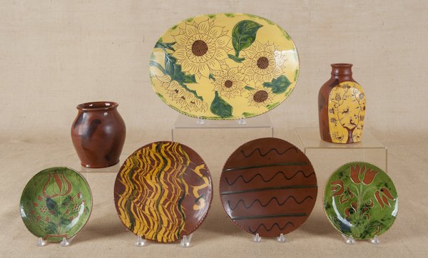 Seven pieces of Breininger redware, to include a: Seven pieces of Breininger redware, to include a crock, plates, etc.