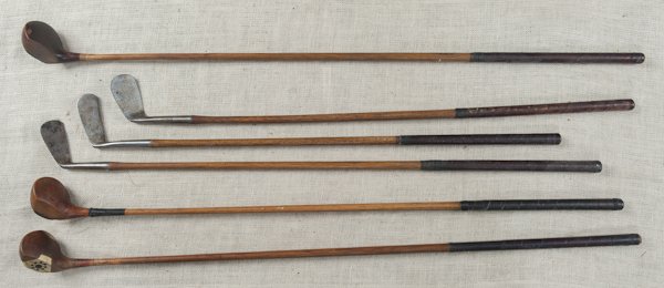 Group of six wooden shaft golf clubs, to include: Group of six wooden shaft golf clubs, to include a St. Andrew's Special Putter, a Mashie, etc.