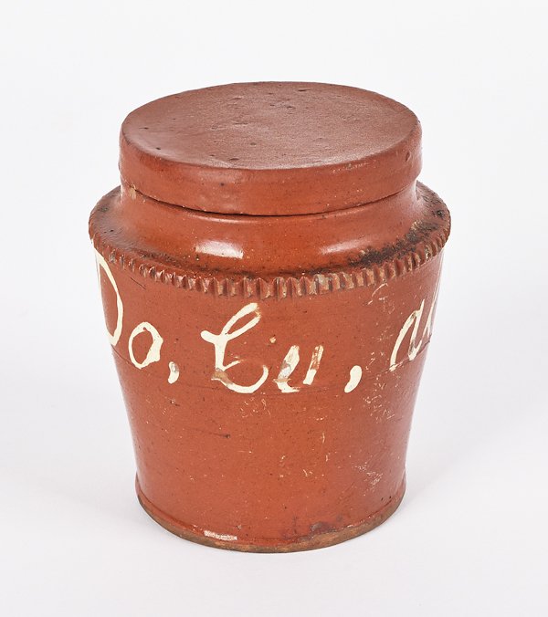 Pennsylvania redware covered jar, 19th c., with: Pennsylvania redware covered jar, 19th c., with slip trailed inscription Do, Cu all, JW (Here they all come), found in Hanover, Pennsylvania, 4 1/2'' h.