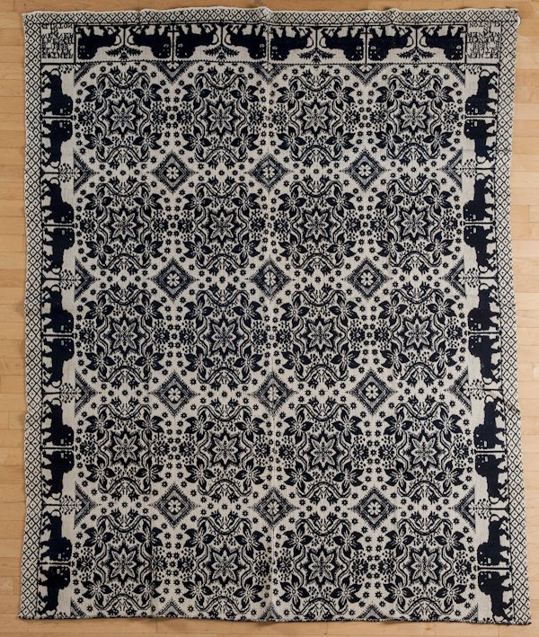 New York blue and white jacquard coverlet, with: New York blue and white jacquard coverlet, with lion and tree border, inscribed Esther Cutler 1838 B. French weaver in Clinton, 89'' x 69 1/2''.