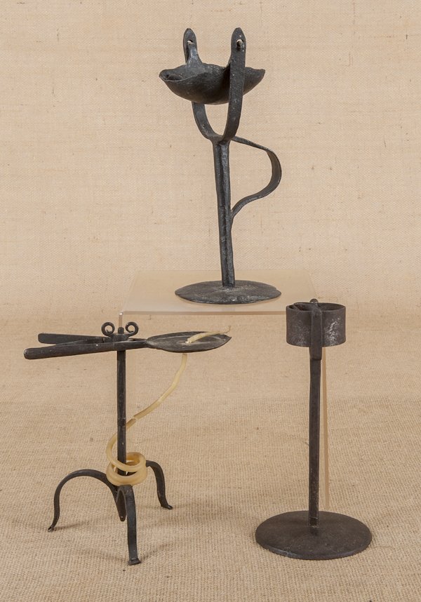 English wrought iron wax jack, ca. 1720, 8'' h.,: English wrought iron wax jack, ca. 1720, 8'' h., together with an iron kettle lamp with a circular base, 8 3/4'' h., and an early wrought iron fat lamp, 10 3/4'' h.