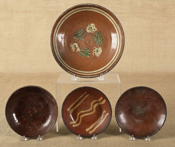 Collection of four redware plates, 19th c., sever: Collection of four redware plates, 19th c., several with slip decoration, largest - 11 1/2'' dia.