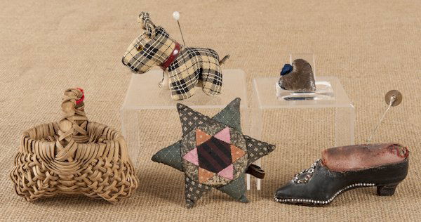 Group of sewing items, to include pincushions and: Group of sewing items, to include pincushions and a heart needle case, together with a miniature splint buttocks basket, 3 1/2'' h.