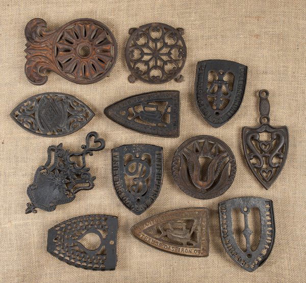 Collection of twelve cast iron trivets, 19th/20th: Collection of twelve cast iron trivets, 19th/20th c.