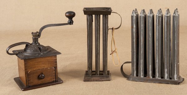 Two tin candlemolds, 19th c., together with a cof: Two tin candlemolds, 19th c., together with a coffee grinder.
