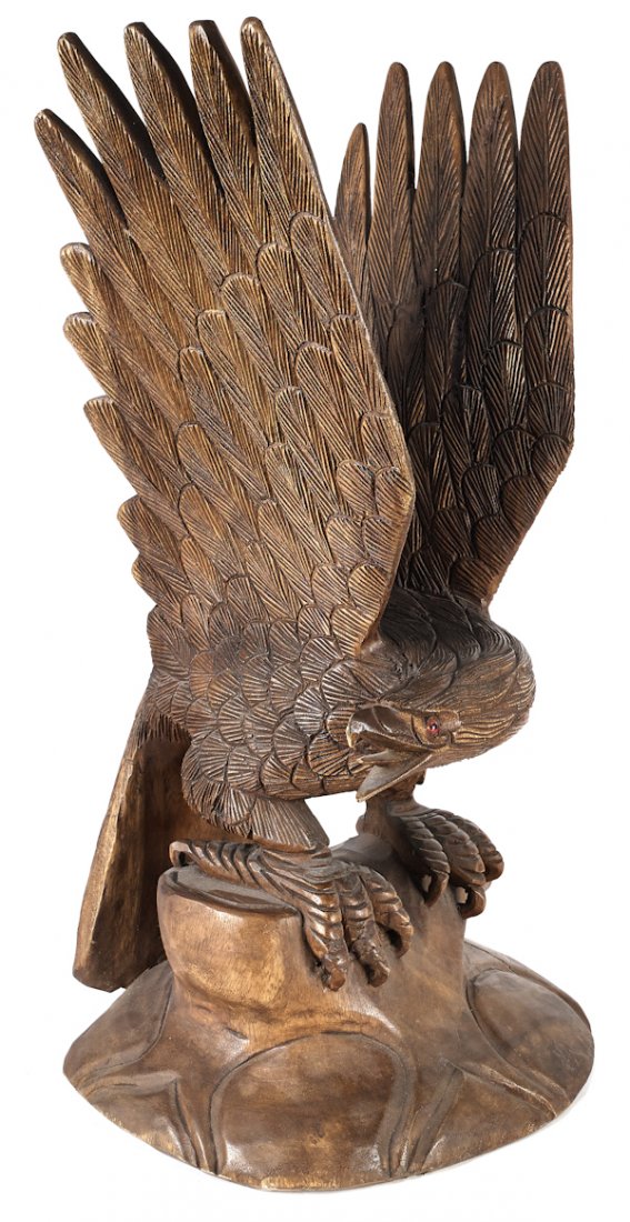 Carved spread wing eagle, 20th c., perched on a l: Carved spread wing eagle, 20th c., perched on a log, 30'' h.