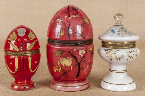 Two Victorian enameled glass egg form decanter se: Two Victorian enameled glass egg form decanter sets with floral decoration, 11 1/2'' h. and 8 1/2'' h., together with an urn form decanter set, 10 1/2'' h.