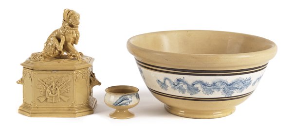 Three pieces of yelloware, to include a mocha mix: Three pieces of yelloware, to include a mocha mixing bowl with seaweed decoration, 6'' h., 12 3/4'' dia., together with a master salt and a humidor with a dog finial, 9'' h.