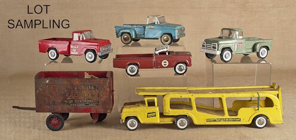 Seven pressed steel trucks, mid 20th c., to inclu: Seven pressed steel trucks, mid 20th c., to include a Buddy L, a Tonka, a Nylint, a Baby Ruth trailer, etc., longest - 26''.