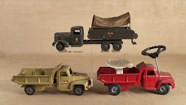 Three pressed steel trucks, mid 20th c., to inclu: Three pressed steel trucks, mid 20th c., to include a Turner Toys Army truck and Buddy L ride-ons, longest - 25''.
