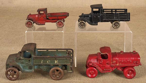 Arcade cast iron Mack Ice truck, 8'' l., togethe: Arcade cast iron Mack Ice truck, 8'' l., together with an Arcade stake truck, 7'' l., an Arcade dump truck, 6'' l., and a gasoline truck, 7'' l.