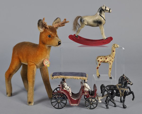 Miscellaneous toys, to include a Steiff deer, 12: Miscellaneous toys, to include a Steiff deer, 12 1/2'' h., a composition rocking horse, a Stanley horse drawn carriage, and a composition giraffe.