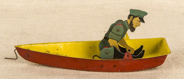 Homemade pressed steel and wood submarine model,: Homemade pressed steel and wood submarine model, 18 3/4'' l., together with an Emmert Hammes and Co. tin litho Barnacle Bill in a row boat rubber band toy, 9'' l.