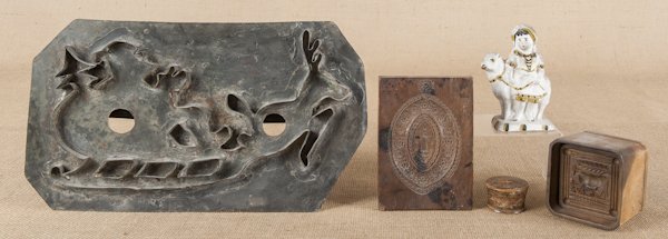 Miscellaneous tablewares, to include a large tin: Miscellaneous tablewares, to include a large tin Santa cookie cutter, a carved cookie board, a cow butter print, a treen box, and a chalk figure of a girl and a lamb.