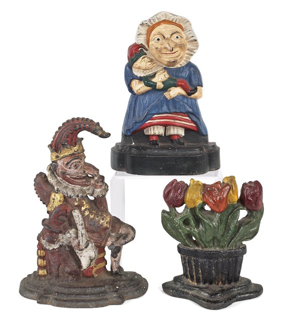 Three cast iron doorstops, to include Punch, Punc: Three cast iron doorstops, to include Punch, Punch and Judy, and a bouquet, tallest - 12''.