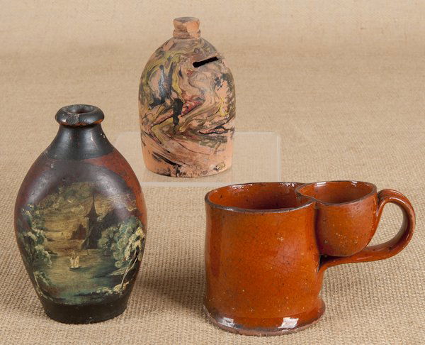 Redware shaving mug, 19th c., together with a pen: Redware shaving mug, 19th c., together with a penny bank and a painted flask, tallest - 5 1/2''.