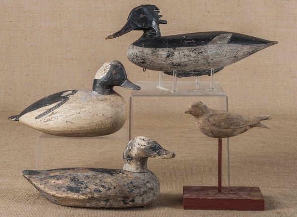 Three carved and painted duck decoys, 20th c., to: Three carved and painted duck decoys, 20th c., together with a bird carving, the bufflehead is signed Tom Savage.