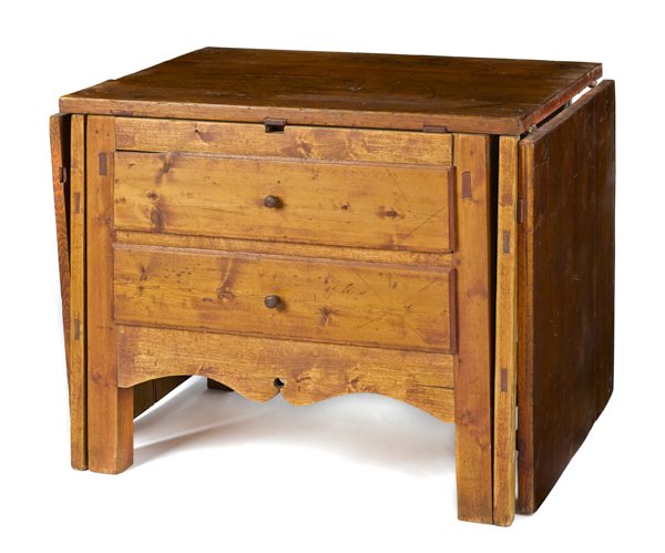 Stained pine work table, mid 19th c., with a dr: Stained pine work table, mid 19th c., with a dropleaf top and two drawers, retaining an old red surface, open - 30 1/2'' h., 95'' w.