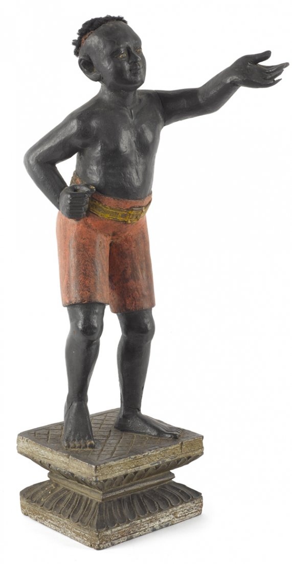 Carved and painted blackamoor figure, 19th c.,: Carved and painted blackamoor figure, 19th c., with yarn hair and cut-off shorts on a carved plinth, 18 1/2'' h.