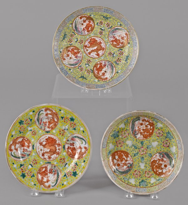 Two Chinese export porcelain plates, 19th c., w: Two Chinese export porcelain plates, 19th c., with five dragon and phoenix panels and a yellow ground, 8 5/8'' dia. and 8'' dia., together with a similar shallow bowl, 7 3/8'' dia.