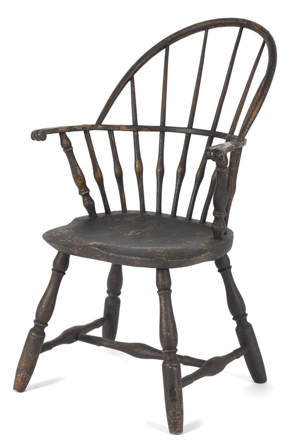 Sackback Windsor chair, 19th c., retaining an e: Sackback Windsor chair, 19th c., retaining an early Spanish brown over salmon surface.