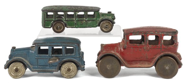 Three cast iron vehicles, to include two sedans a: Three cast iron vehicles, to include two sedans and a bus, longest - 5''.