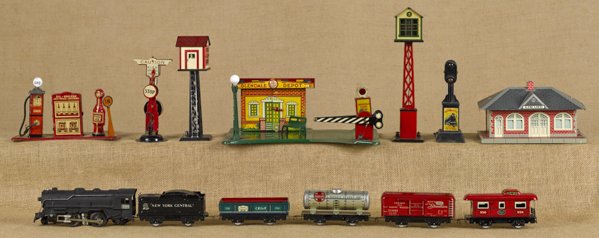 Marx O gauge six-piece train set, to include a #9: Marx O gauge six-piece train set, to include a #999 Engine, a Tender, a #555 Boxcar, a #552 Gondola, a #553 Tanker, and a #556 Caboose, together with a Girard station, a Glendale Depot, two switchman 